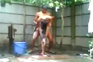 Indian Girl Bathing outside nude and faking a street boy poster